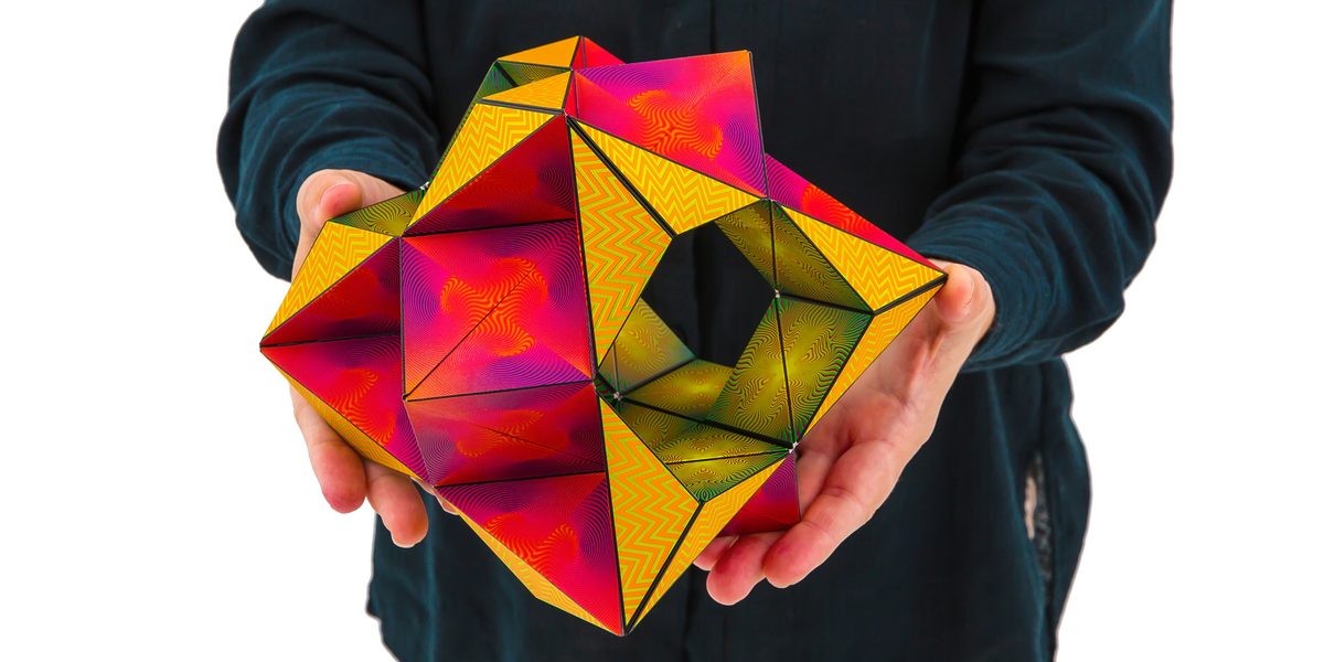 Hands holding a Shashibo unfolded into a star